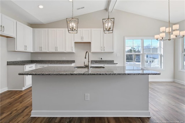 5411 Seedling Rd, Fayetteville, NC 28311 - kitchen featuring a chandelier, a sink, stone counters, white cabinetry, and recessed lighting