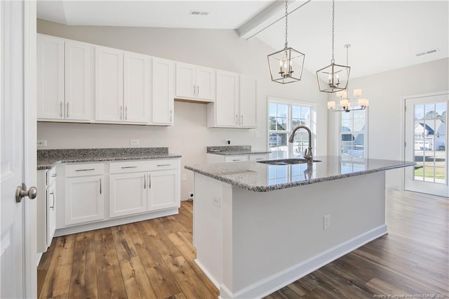 5411 Seedling Rd, Fayetteville, NC 28311 - kitchen with a sink, wood-type flooring, a chandelier, and white cabinetry