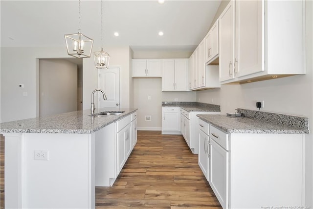 5411 Seedling Rd, Fayetteville, NC 28311 - kitchen featuring a sink, light wood-style floors, recessed lighting, an island with sink, and light stone countertops