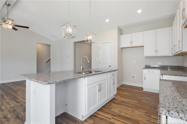 5411 Seedling Rd, Fayetteville, NC 28311 - kitchen featuring a sink, baseboards, dark wood-type flooring, white cabinets, and recessed lighting