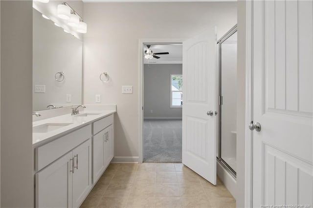 5411 Seedling Rd, Fayetteville, NC 28311 - full bath with double vanity, ceiling fan, an enclosed shower, baseboards, and tile patterned flooring