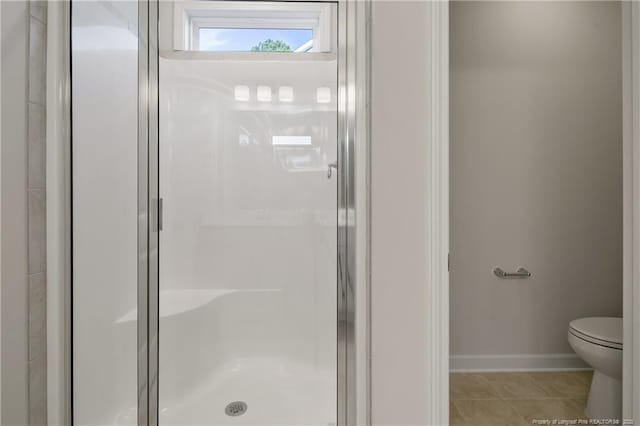 5411 Seedling Rd, Fayetteville, NC 28311 - full bath featuring a stall shower, toilet, baseboards, and tile patterned floors