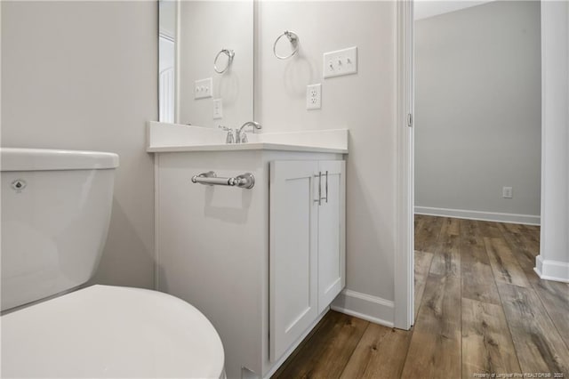5411 Seedling Rd, Fayetteville, NC 28311 - bathroom featuring toilet, wood finished floors, vanity, and baseboards