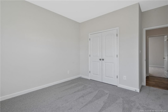 5411 Seedling Rd, Fayetteville, NC 28311 - unfurnished bedroom with carpet, baseboards, and a closet