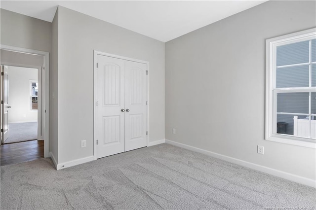5411 Seedling Rd, Fayetteville, NC 28311 - unfurnished bedroom with carpet flooring, baseboards, and a closet