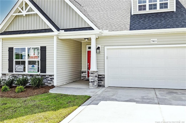 5411 Seedling Rd, Fayetteville, NC 28311 - view of front of house with roof with shingles, board and batten siding, driveway, and stone siding