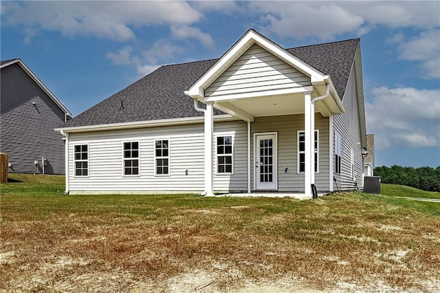5411 Seedling Rd, Fayetteville, NC 28311 - rear view of house featuring a lawn, a shingled roof, and central AC