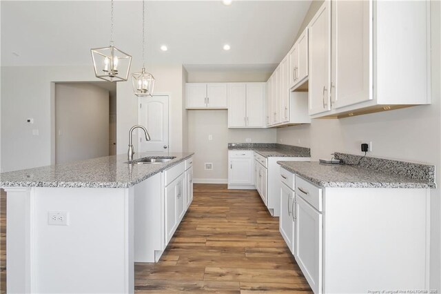 5411 Seedling Rd, Fayetteville, NC 28311 - kitchen featuring a sink, light wood-style flooring, recessed lighting, light stone counters, and white cabinets
