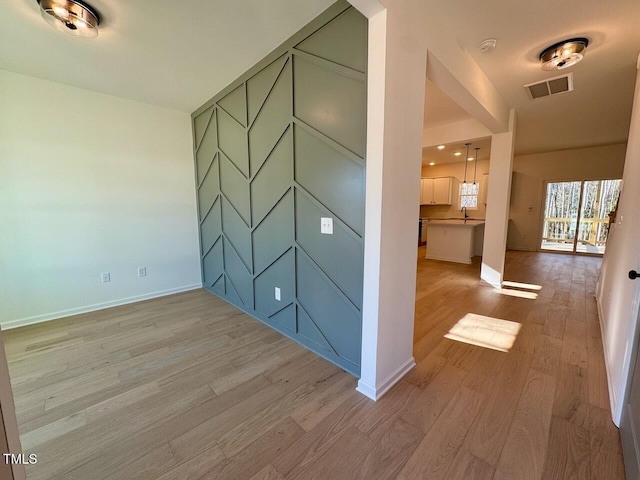 interior space featuring light wood-type flooring and sink