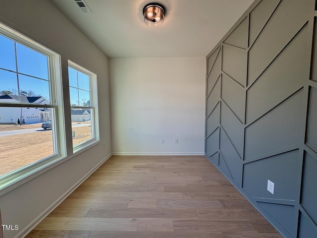 spare room featuring light hardwood / wood-style floors