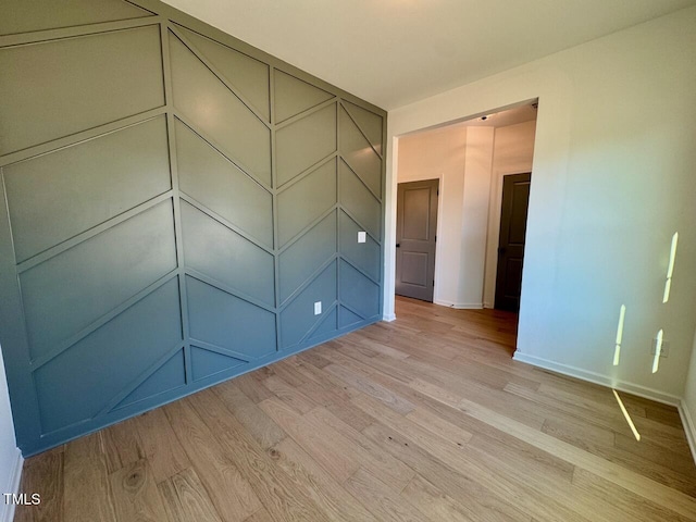 spare room featuring light wood-type flooring