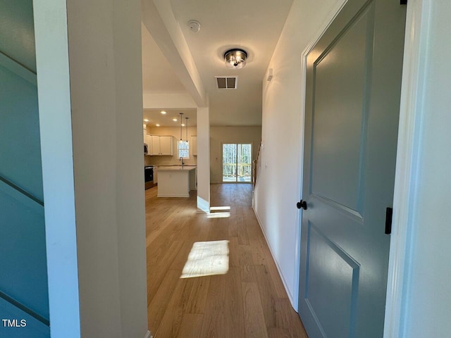 corridor featuring light hardwood / wood-style floors