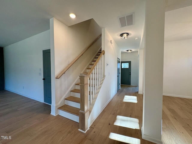 stairway with hardwood / wood-style flooring