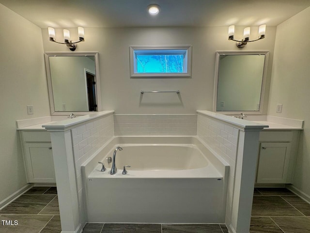 bathroom with vanity and a bath