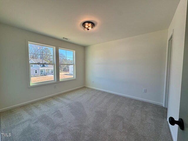 spare room featuring carpet