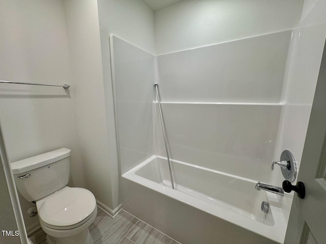 bathroom featuring toilet and washtub / shower combination