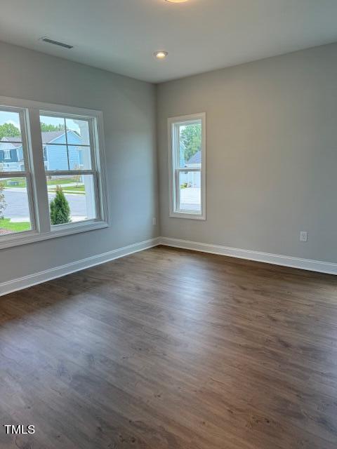 empty room with dark wood-type flooring