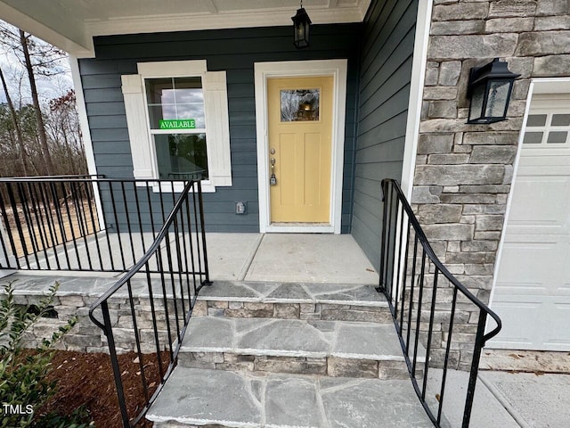 view of exterior entry featuring a garage