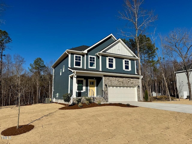 view of front of property featuring central AC unit, a garage, and covered porch