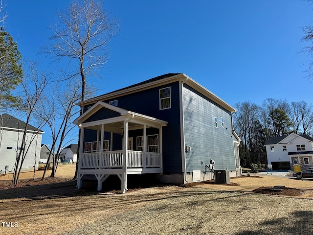 back of house featuring central AC unit and covered porch