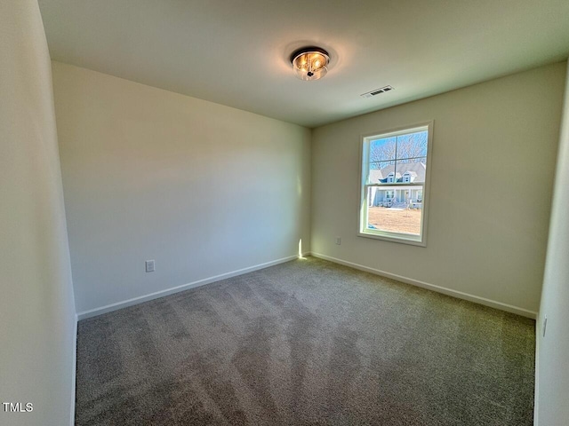 unfurnished room featuring dark colored carpet