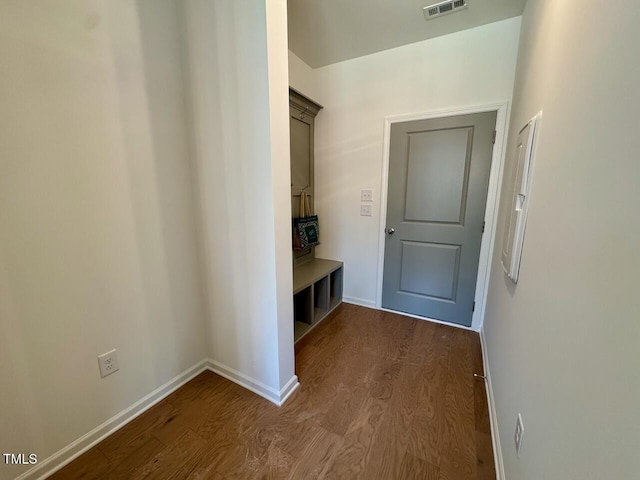 mudroom featuring baseboards, visible vents, and dark wood-style flooring