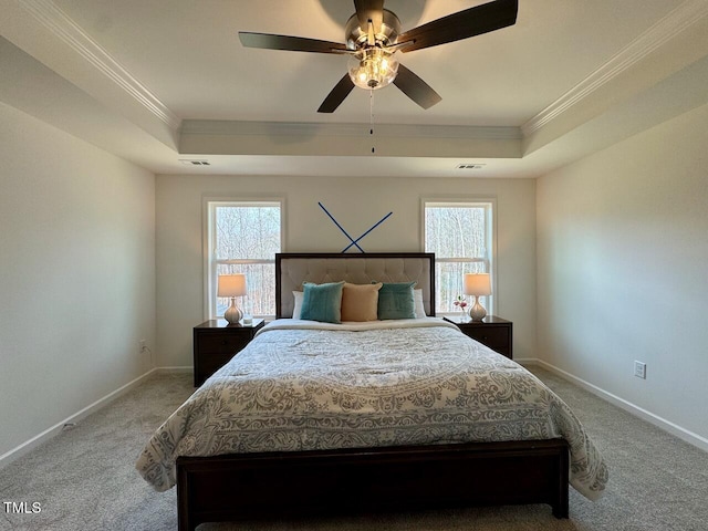 bedroom featuring carpet, a raised ceiling, visible vents, and baseboards