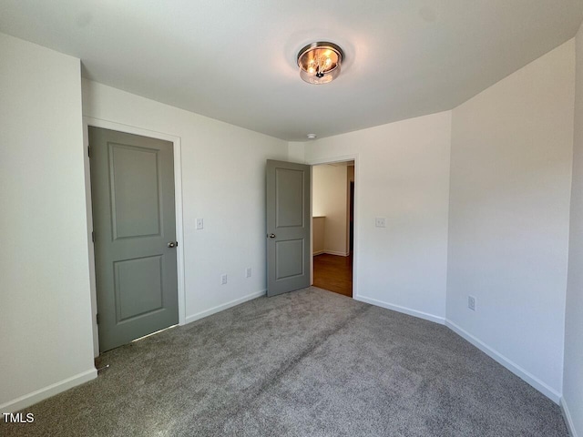 unfurnished bedroom with carpet floors and baseboards