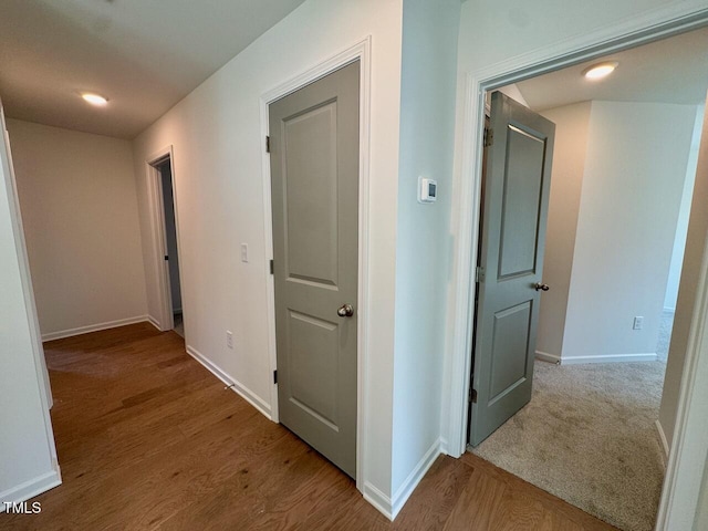 hallway with baseboards and wood finished floors