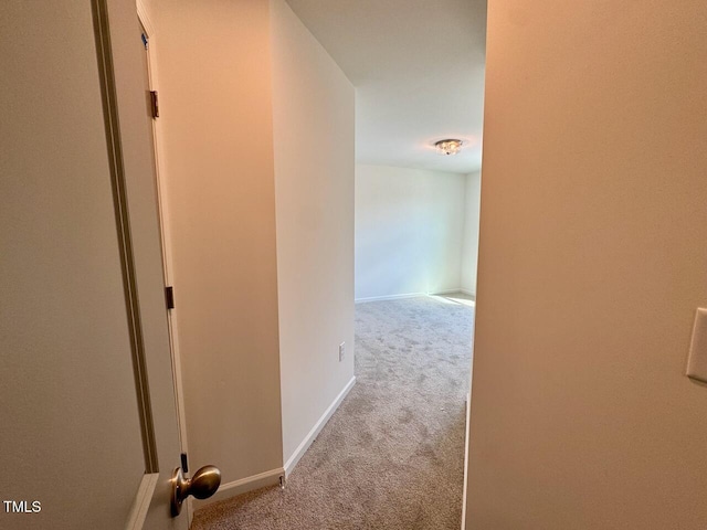 hall with carpet flooring and baseboards