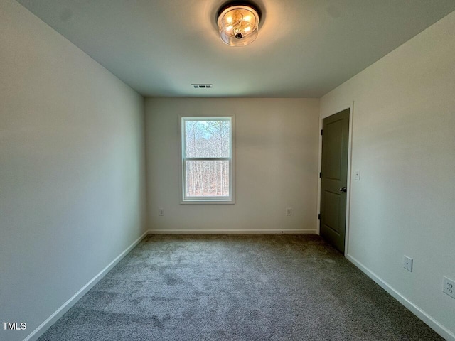 carpeted empty room featuring baseboards and visible vents