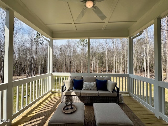 sunroom featuring a ceiling fan and a healthy amount of sunlight