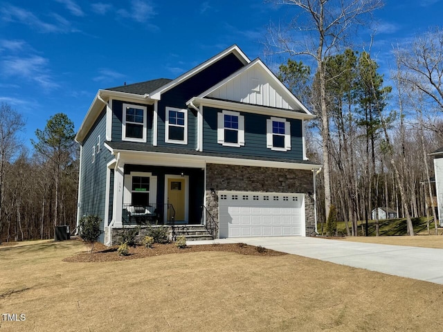 view of front of home featuring a garage, concrete driveway, stone siding, a porch, and board and batten siding