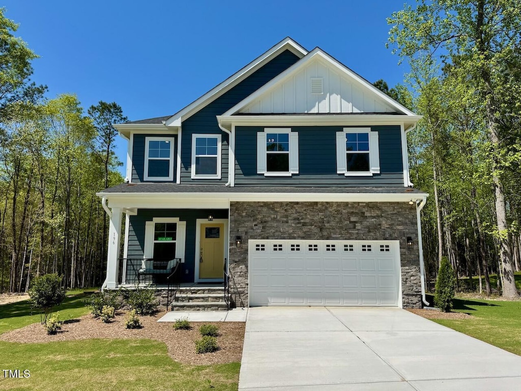 196 Grand Griffon Way, Lillington, NC 27546 - craftsman-style house with covered porch, board and batten siding, driveway, an attached garage, and stone siding