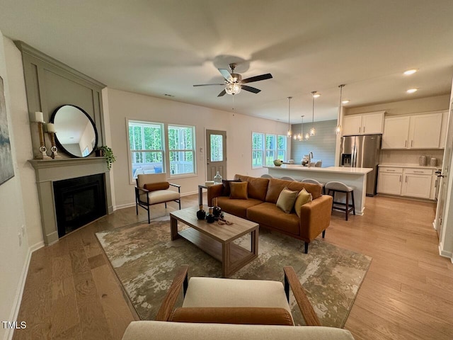 196 Grand Griffon Way, Lillington, NC 27546 - living area with a ceiling fan, a fireplace, light wood-style floors, baseboards, and recessed lighting