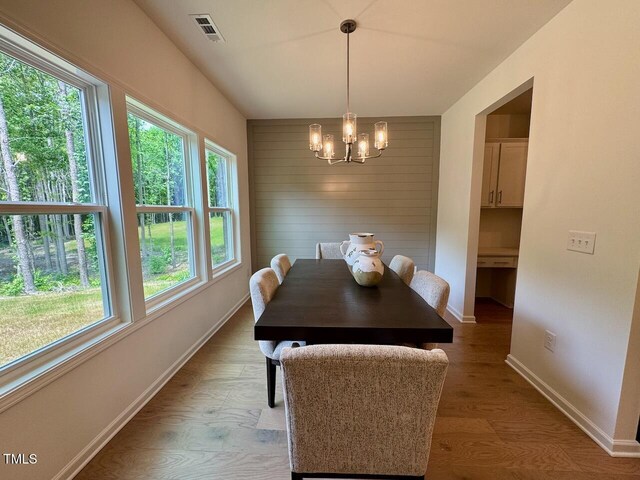 196 Grand Griffon Way, Lillington, NC 27546 - dining room featuring a chandelier, light wood-type flooring, and baseboards