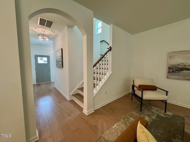 196 Grand Griffon Way, Lillington, NC 27546 - stairway featuring arched walkways, wood finished floors, and baseboards