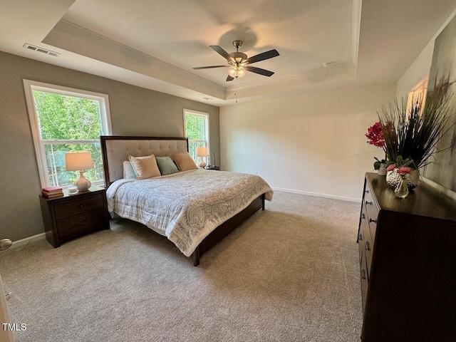 196 Grand Griffon Way, Lillington, NC 27546 - bedroom featuring a tray ceiling, baseboards, light colored carpet, a ceiling fan, and crown molding
