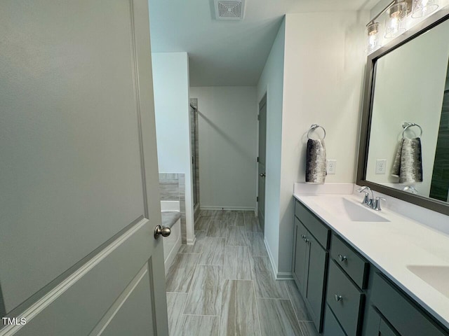 196 Grand Griffon Way, Lillington, NC 27546 - bathroom featuring a stall shower, double vanity, baseboards, and a bathtub