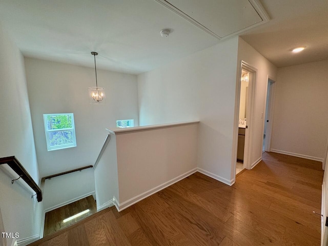 196 Grand Griffon Way, Lillington, NC 27546 - corridor with an upstairs landing, wood finished floors, attic access, and baseboards