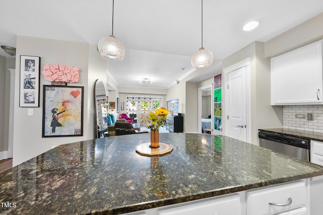 kitchen featuring ornamental molding, white cabinetry, tasteful backsplash, and hanging light fixtures