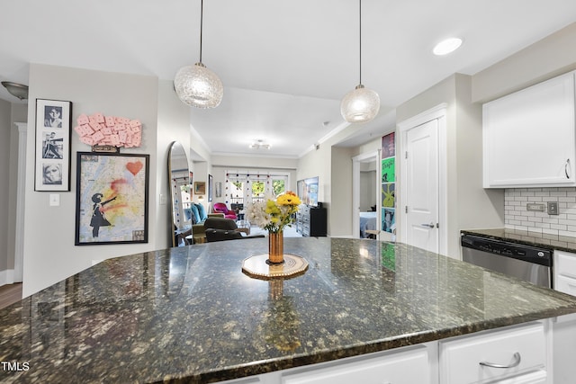 kitchen featuring hanging light fixtures, white cabinetry, and dishwasher