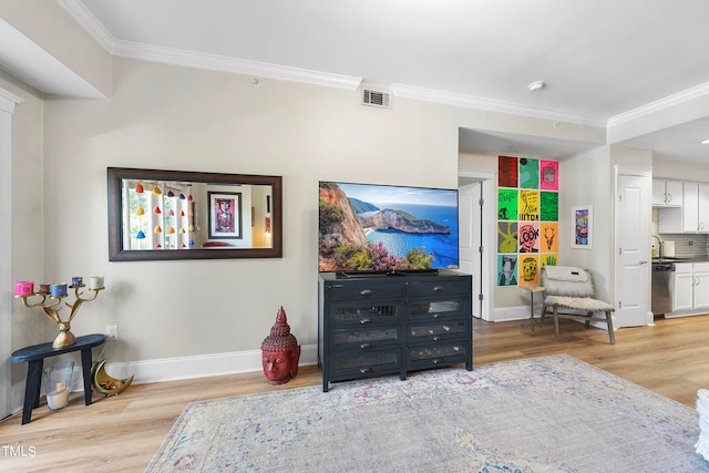 interior space featuring light hardwood / wood-style floors, sink, and ornamental molding