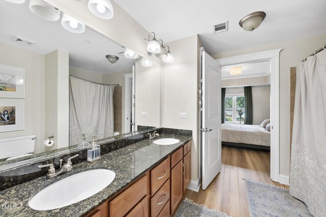 bathroom featuring hardwood / wood-style floors and double sink vanity