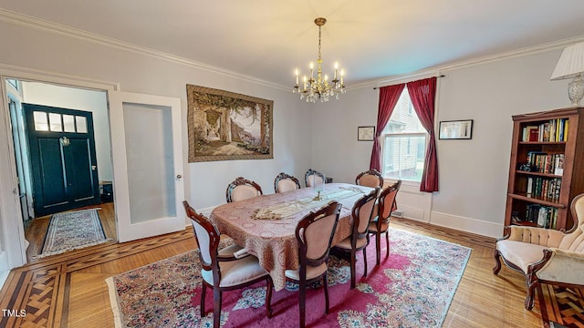 dining area with ornamental molding, light wood finished floors, and an inviting chandelier