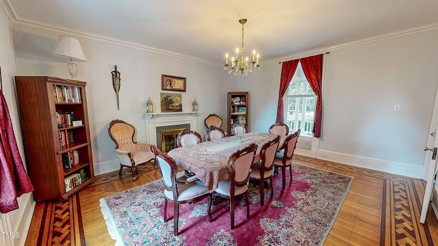 dining space with baseboards, a fireplace, an inviting chandelier, and crown molding