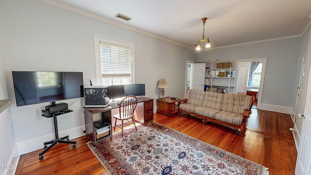 home office with ornamental molding, wood finished floors, visible vents, and baseboards