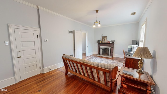 bedroom featuring baseboards, crown molding, visible vents, and wood finished floors