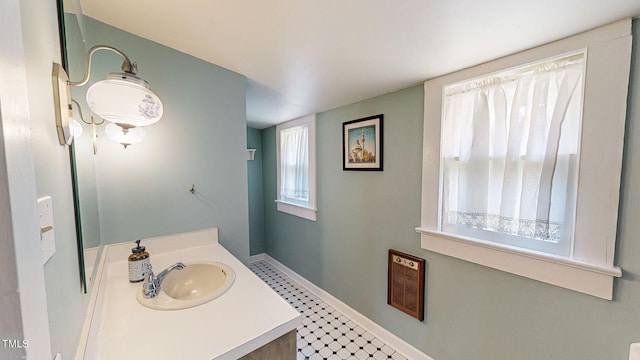 bathroom with vanity and baseboards