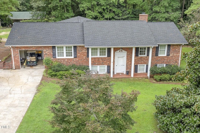 view of front of house featuring a garage and a front lawn